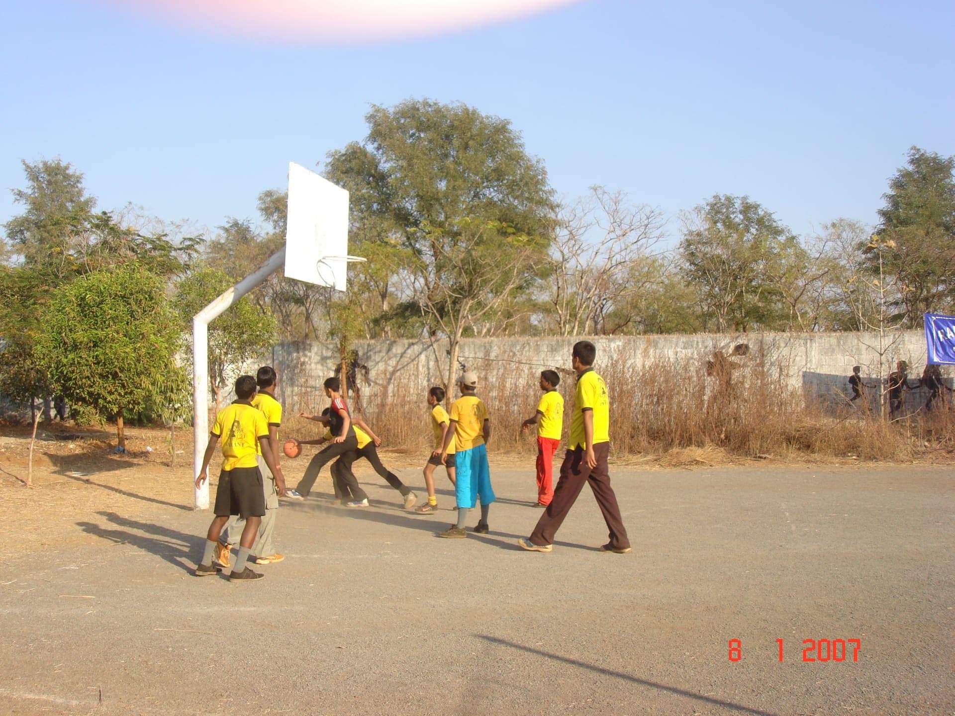 Boys playing basketball on the school grounds