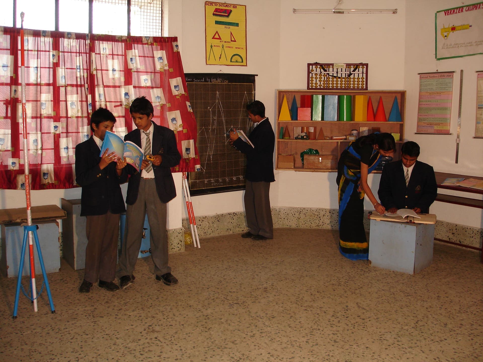 A teacher guiding students during a mathematics lesson