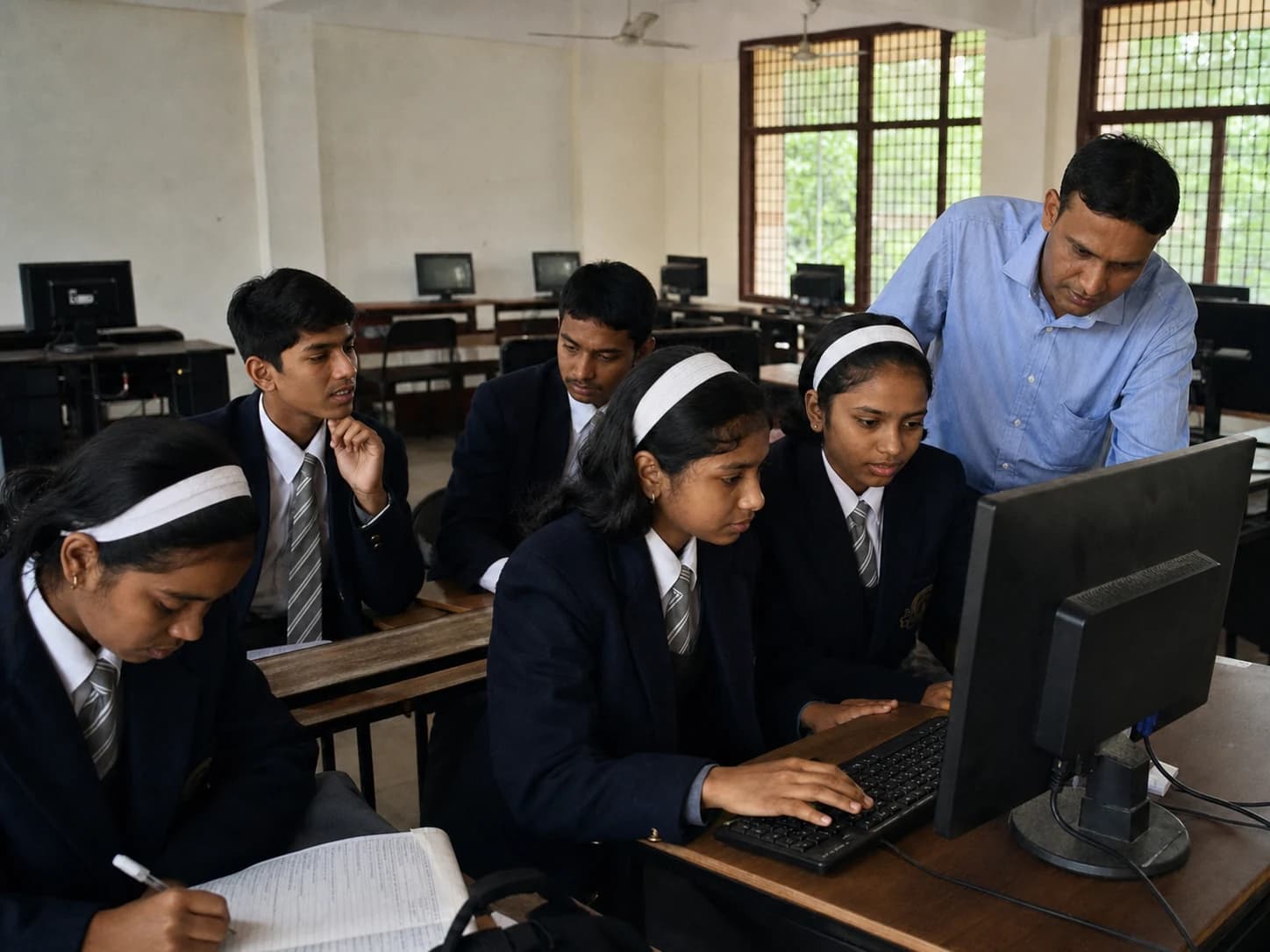 Students working in pairs during a supervised computer laboratory lesson