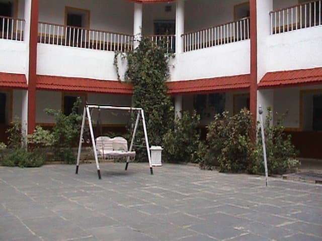 The inner courtyard at Radiant: a swing seat under a two-storey verandah
