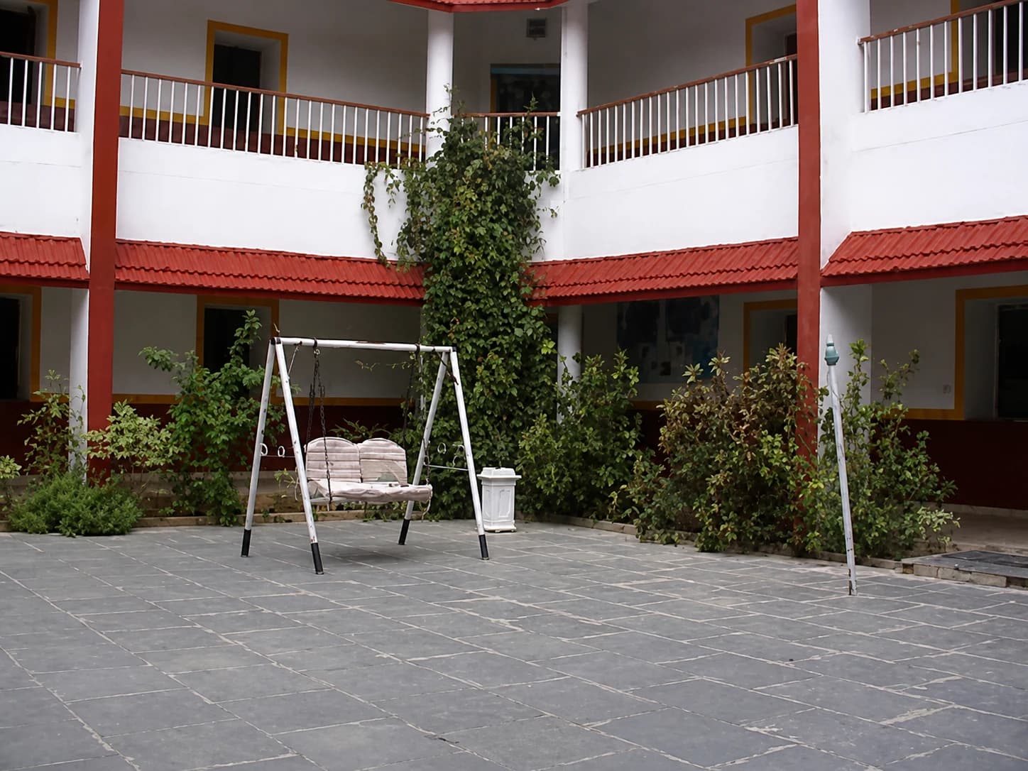 The inner courtyard at Radiant: a swing seat under a two-storey verandah
